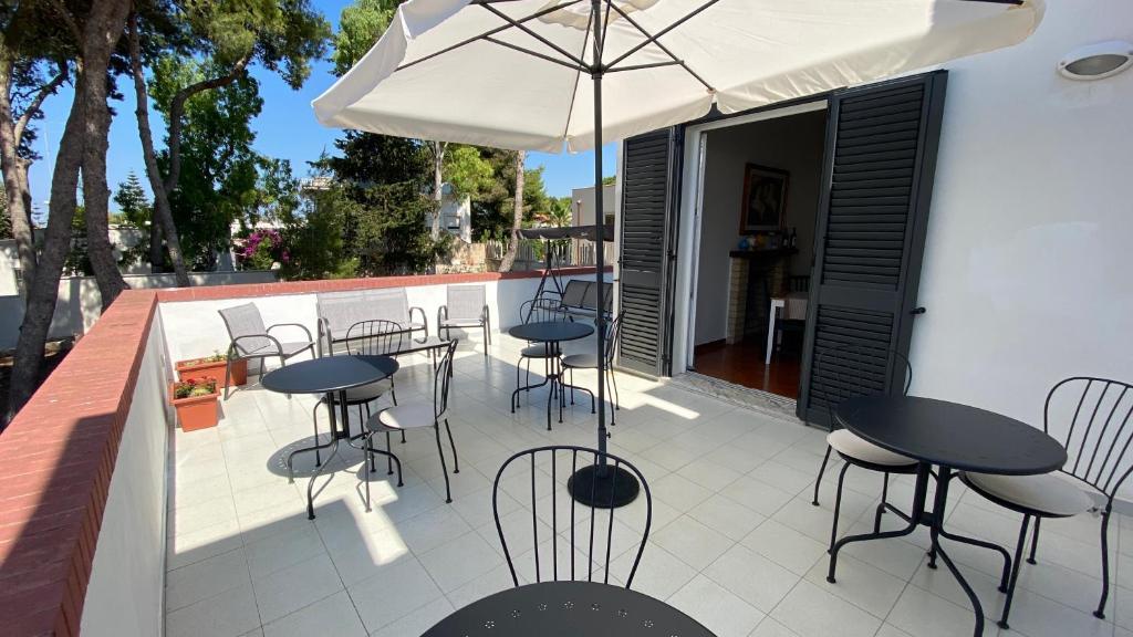 Shaded terrace with tables at Villa Iavernaro